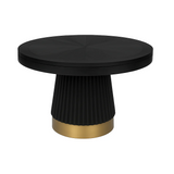 Round black table with a gold base on a white background