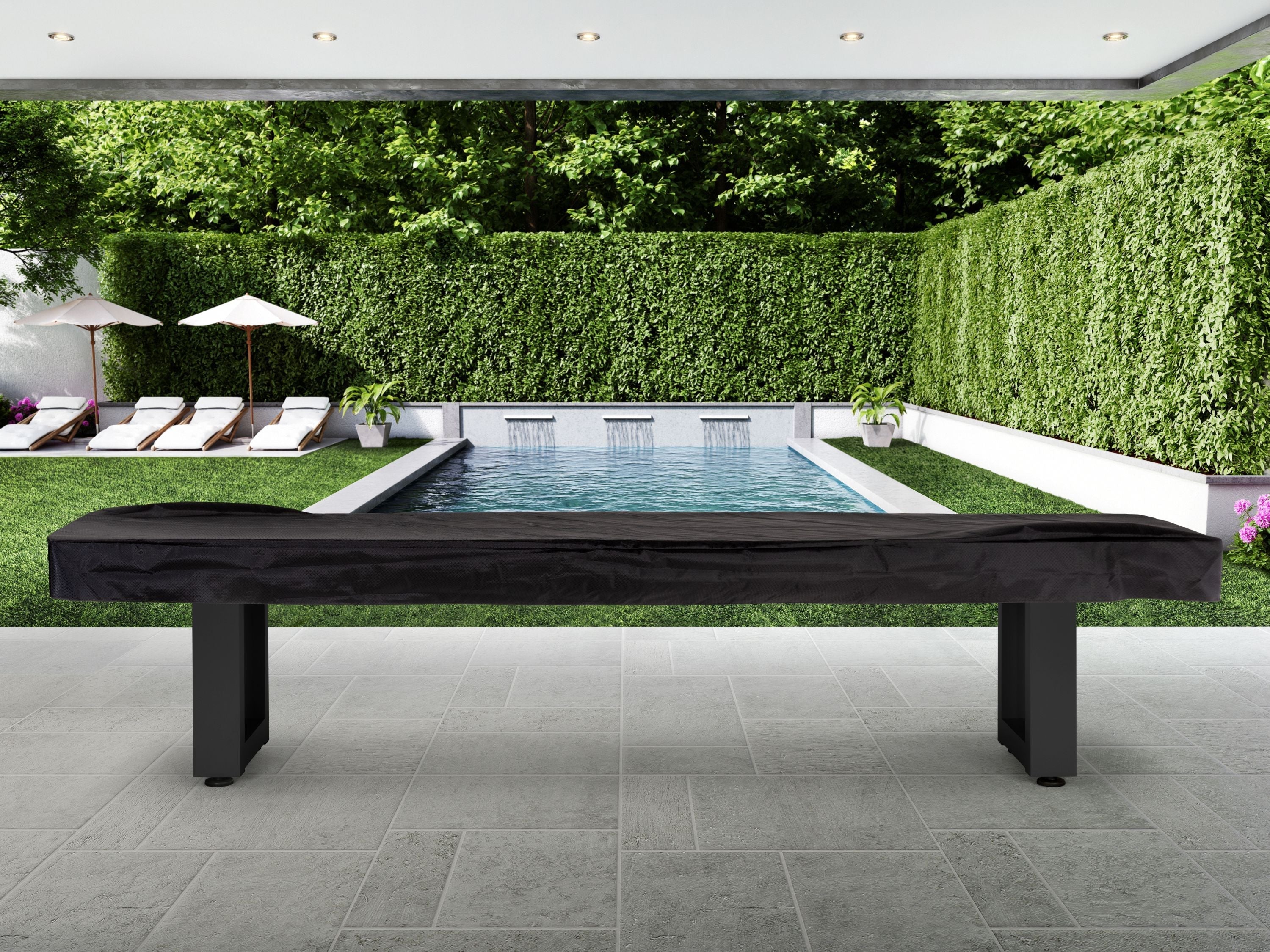 American Heritage Lanai 12' Obsidian Black shuffleboard table is set on a patio near the pool.
