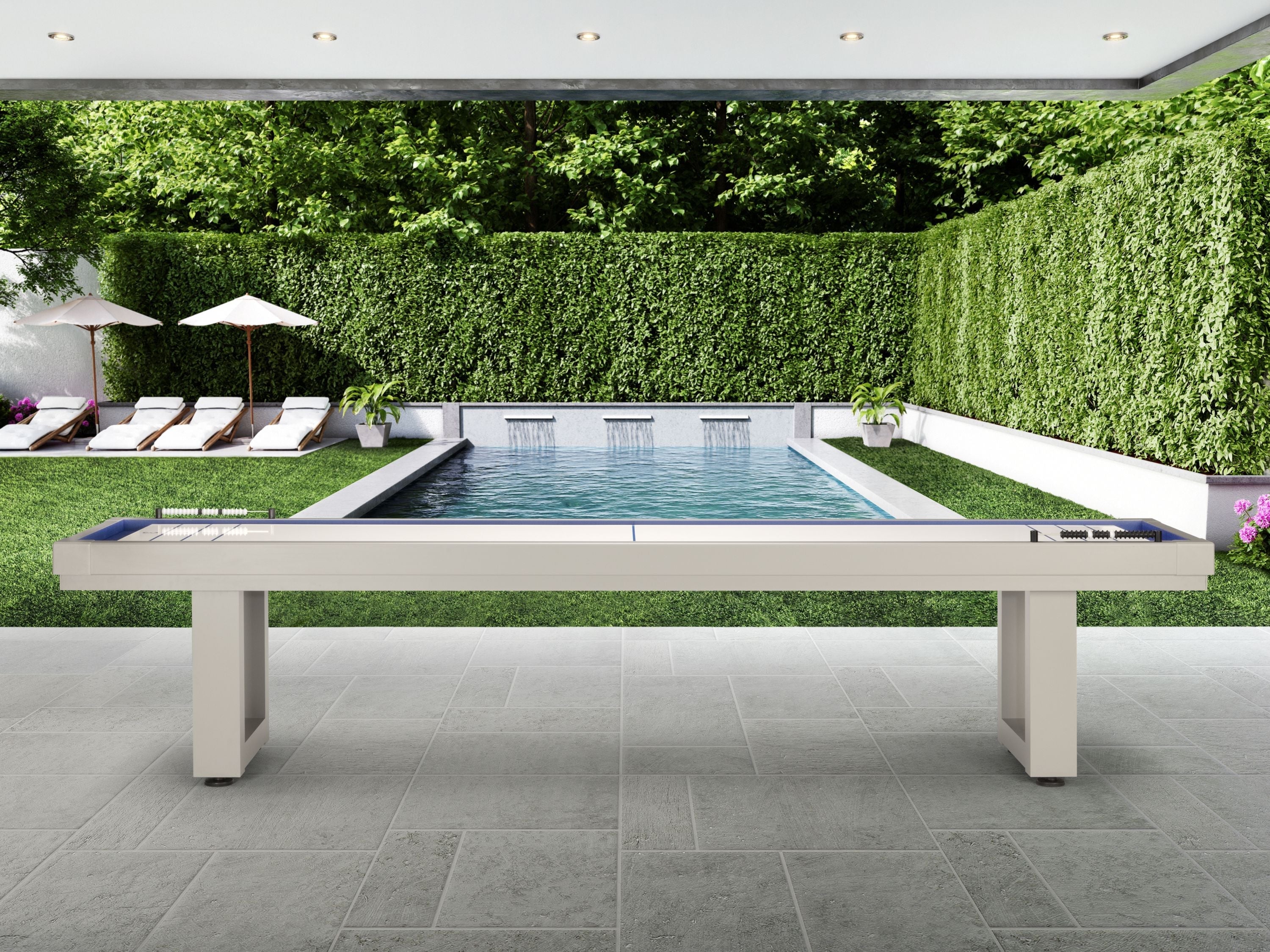 American Heritage Lanai 12' Oyster Grey Shuffleboard Table by the pool with lounge chairs.