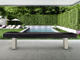 American Heritage Lanai 12' Oyster Grey shuffleboard table on patio, pool and lounge chairs behind.